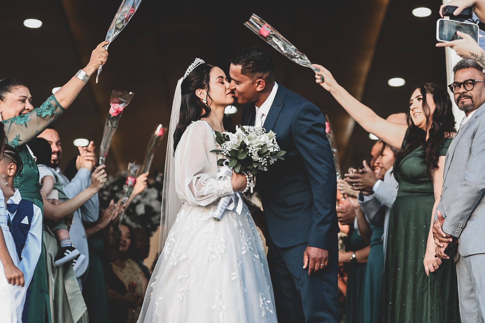 Noivos saindo da cerimônia sob chuva de flores, casamento em São José dos Campos